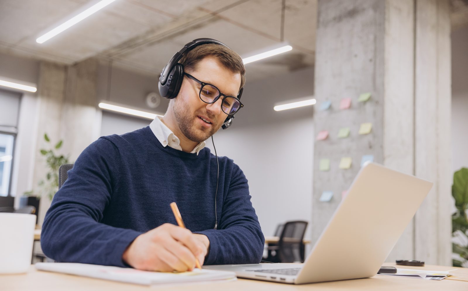A planning consultant taking notes during a video consultation